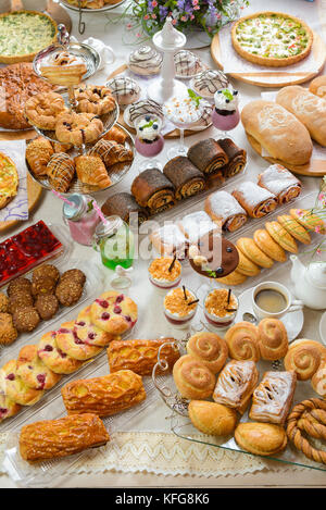 Table full of assorted confectionery sweets and desserts Stock Photo