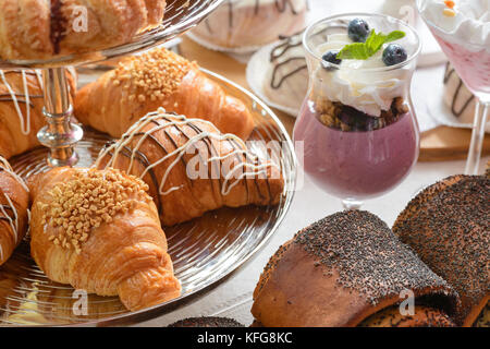 Table full of assorted confectionery sweets and desserts Stock Photo