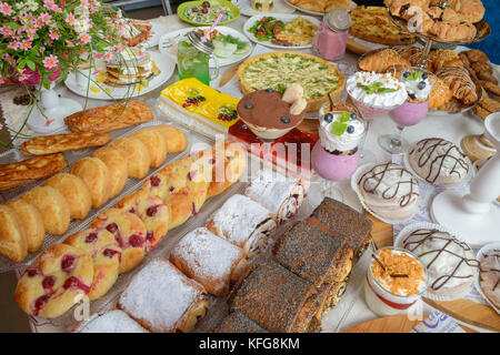 Table full of assorted confectionery sweets and desserts Stock Photo