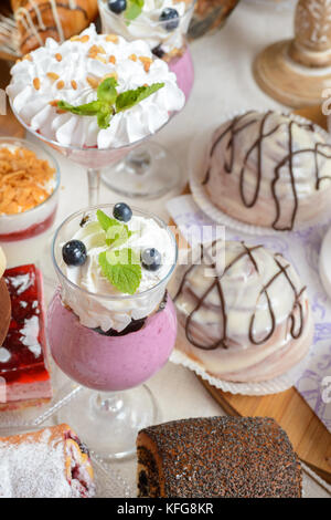 Table full of assorted confectionery sweets and desserts Stock Photo