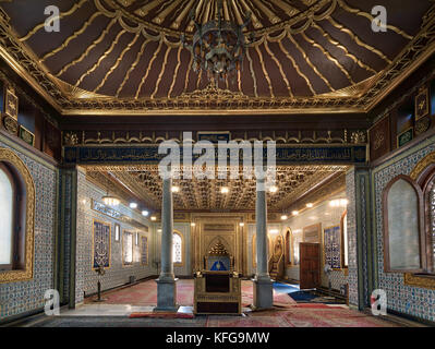 Interior of public mosque of Manial Palace of Prince Mohammed Ali Tewfik with wooden golden ornate ceilings with design based on old logo of the ottom Stock Photo
