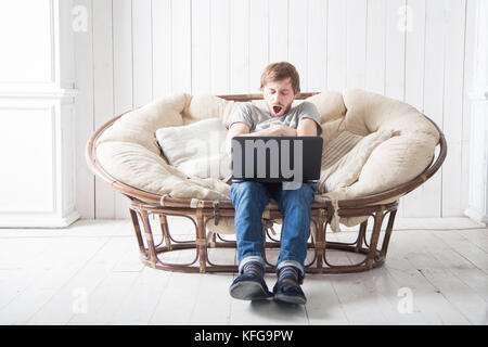 Feeling exhausted. The guy was tired and fell asleep at the computer. Stock Photo