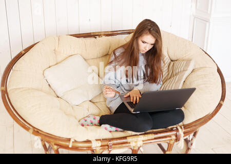Woman's hands holding a credit card and using laptop for online shopping Stock Photo