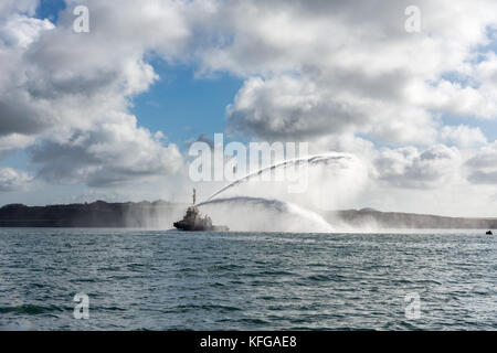 Svitzer Gelliswick outputting impressive jets of water from the fire fighting nozzles in Milford Haven on a calm day Stock Photo
