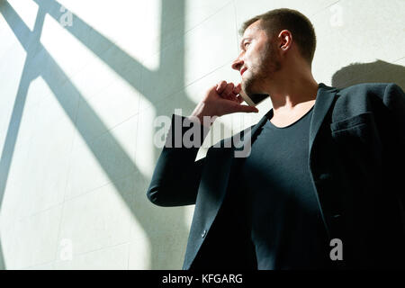Handsome Man Speaking by Phone in Sunlight Stock Photo