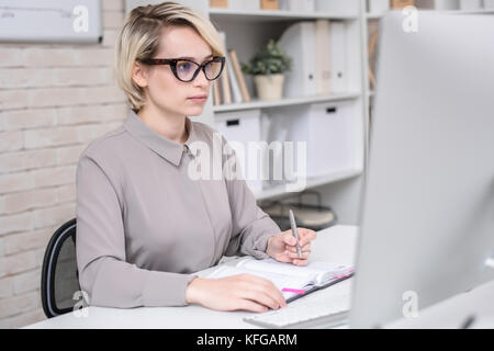 Busy Businesswoman Working in Office Stock Photo
