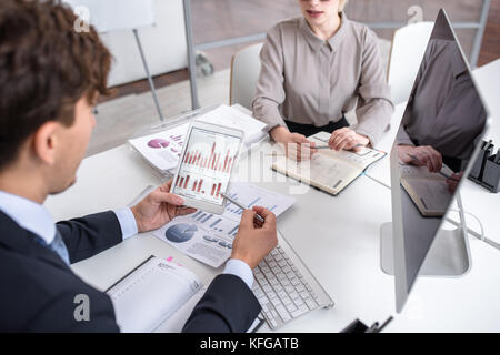 Business People Analyzing Marketing and Finance Report Stock Photo