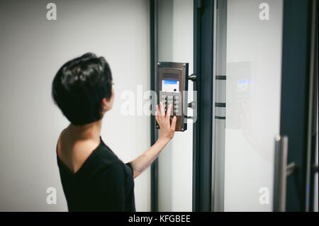 woman is calling on the intercom Stock Photo
