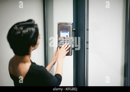woman is calling on the intercom Stock Photo