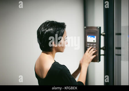 woman is calling on the intercom Stock Photo