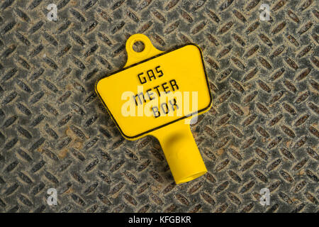 Plastic key for an exterior gas meter box on a metal background Stock Photo