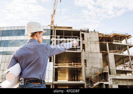 Chief Construction with drawings manages the facility Stock Photo