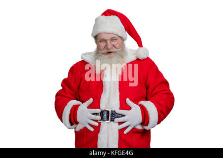 Old Santa with hands on belly. Portrait of realistic Santa Claus holding hands on belly and looking at camera. Authentic Santa Claus, studio shot. Stock Photo