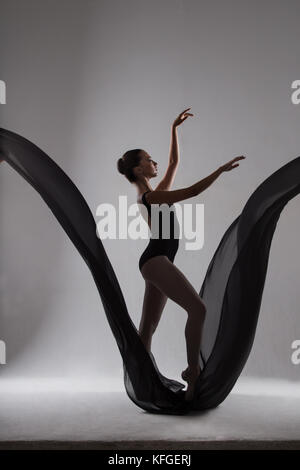 A gorgeous, elegant ballerina in black tights. Studio photography