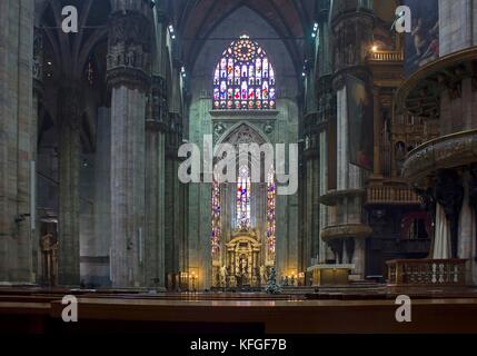 MILAN, ITALY - MAY 11 2014: Duomo Catheral in Milan, interiors of the liturgic area with benches and the altar, no people Stock Photo