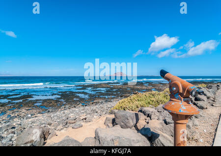 view of Lobo's Island from Corralejo with a telescope in the foreground, Corralejo, Fuerteventura, Canary Islands, Spain Stock Photo