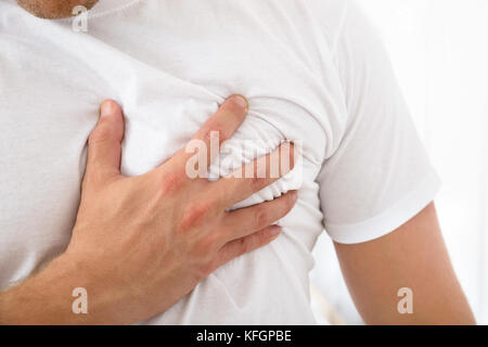 Close-up Of A Man Suffering From Chest Pain Stock Photo