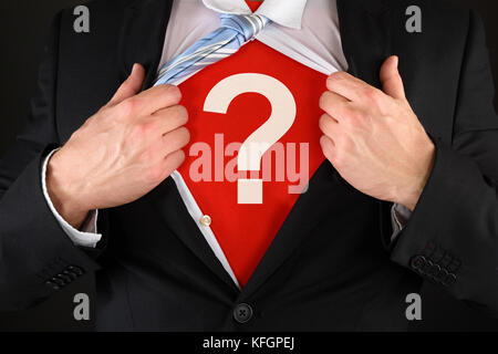 Close-up Of A Businessman Showing Question Mark Symbol Under His Suit Stock Photo