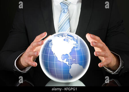 Close-up Photo Of Businessman Hand On Globe Stock Photo