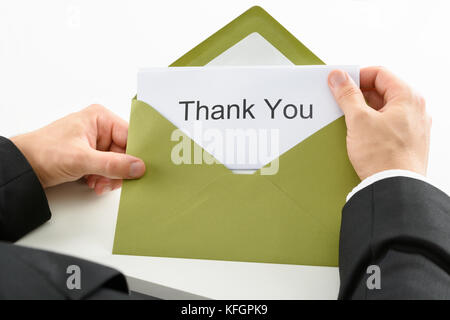 Businessman Holding Thank You Card In Green Envelope Stock Photo