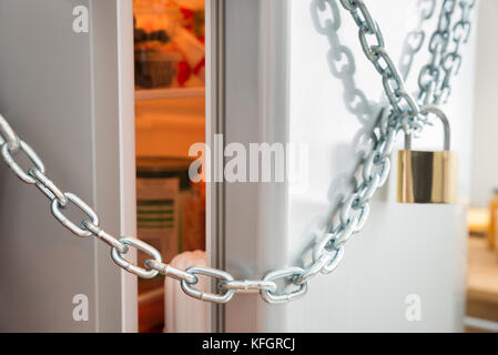 Opened Door Of Fridge Locked With Chain And Padlock Stock Photo