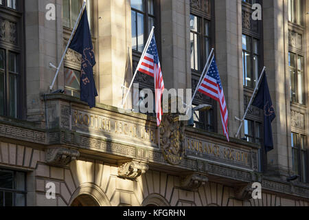 US flags hang from the Scottish Legal Life Assurance Society building in Glasgow city centre which has been transformed into New York City for filming of the TV show Melrose. Stock Photo