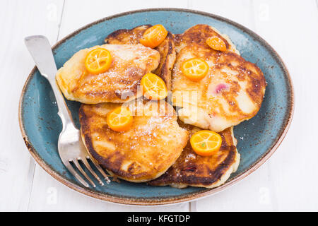 Sweet pancakes with fruit on white tree Stock Photo