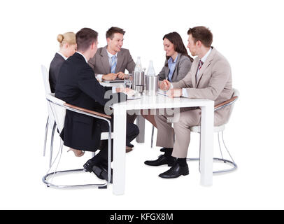 Full length of business people having conference meeting over white background Stock Photo