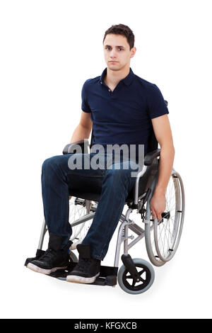Full length portrait of confident young man sitting in wheelchair isolated over white background Stock Photo