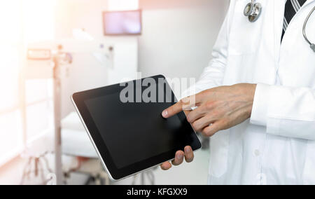 Smart health care internet of things and hospital automation management technology concept with paperless. Doctor with Stethoscope using black display Stock Photo