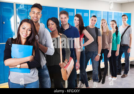 Group Of Happy Multiethnic College Students Standing In A Row Stock Photo