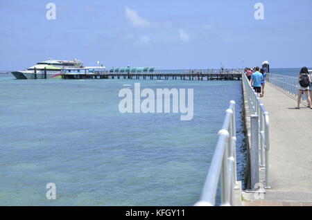 A Cairns ferry discharges tourists at the wharf at the resort of Green Island on the Great barrier reef in northern Queensland, Australia Stock Photo