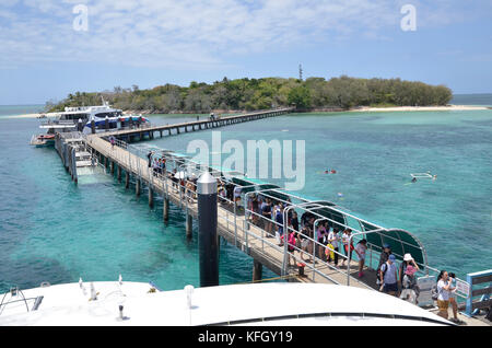 A Cairns ferry discharges tourists at the wharf at the resort of Green Island on the Great barrier reef in northern Queensland, Australia Stock Photo