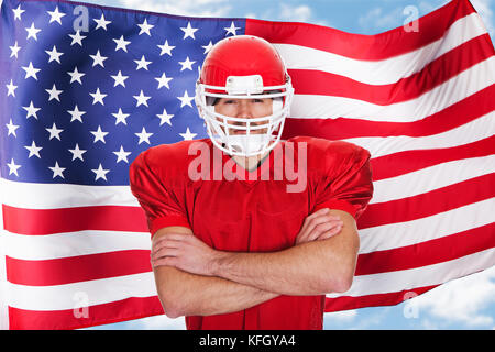 American Football Sportsman Player Standing In Front Of American Flag Stock Photo