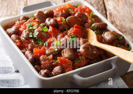 Nourishing food: stewed broad beans with tomatoes and herbs closeup on the table. horizontal Stock Photo