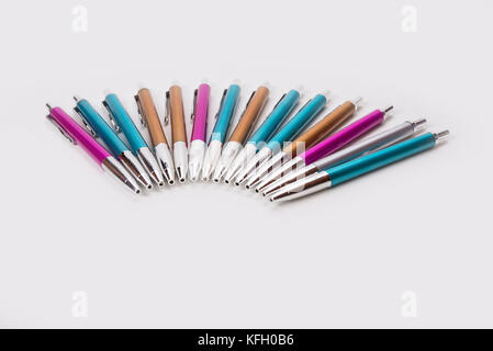 Blue pink and brown ballpoint pens on white background Stock Photo