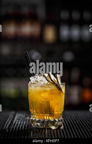 Close up of glass with iced refreshing cocktail with lime and passion fruit Stock Photo