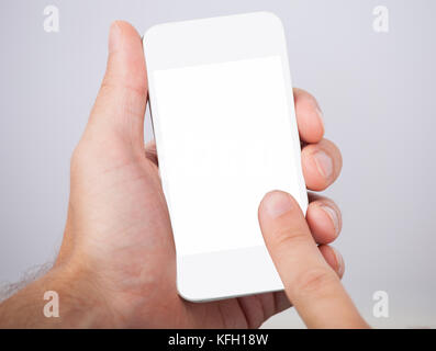 Closeup of hand holding smartphone with blank screen Stock Photo
