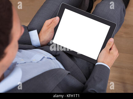 Overhead view of businessman holding digital tablet in office Stock Photo