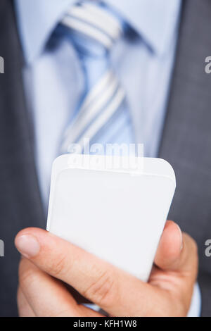 Closeup photo of businessman using his smartphone Stock Photo