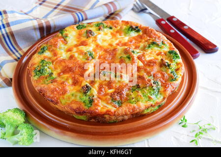 Broccoli pie on a brown ceramic plate. Healthy eating concept. Stock Photo