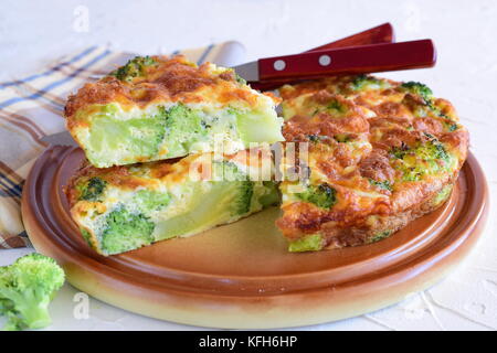 Broccoli pie on a brown ceramic plate. Healthy eating concept. Stock Photo