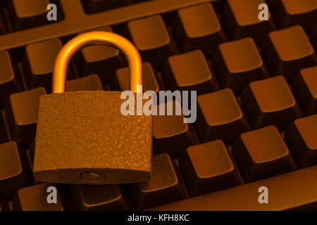 Small padlock on a black blanked keyboard - for cyber threat, cyber security, data and email security, email privacy & secure login concept. Stock Photo