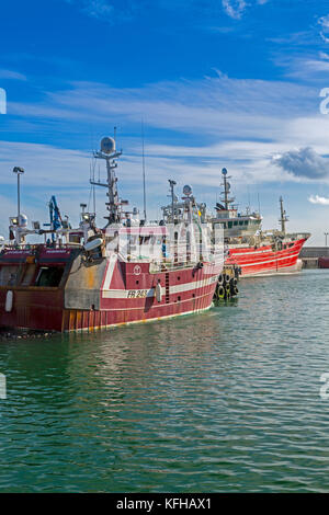 A mixture of different designs and sizes of fishing vessels in Fraserburgh harbour, Aberdeenshire, Scotland, UK Stock Photo
