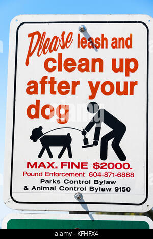 Sign 'Please leash and clean up after your dog' Stock Photo