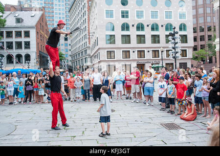 Street artists entertaining tourists outside Quincy Market in Boston, Massachusetts Stock Photo