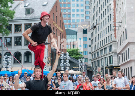 Street artists entertaining tourists outside Quincy Market in Boston, Massachusetts Stock Photo