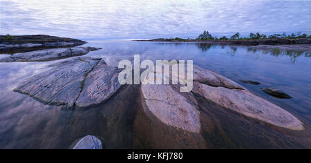 Lakeside panorama taken at early morning at Ladoga skerries, Karelia region, Russia. Skerries of the Ladoga lake is a system of approximately 650 rock Stock Photo