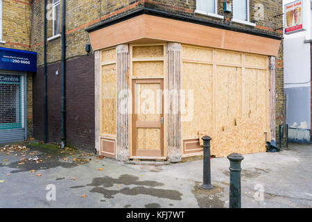 An empty shop boarded up before being re-fitted. Stock Photo
