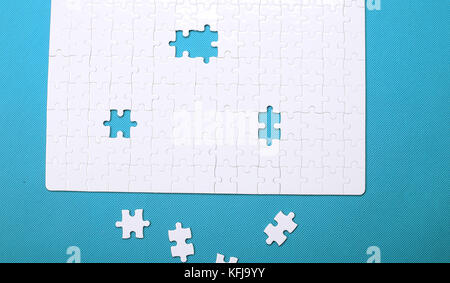 White details of a puzzle on green background. A puzzle is a puz Stock Photo
